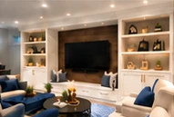 A comfortable entertainment space with built-in shelving.